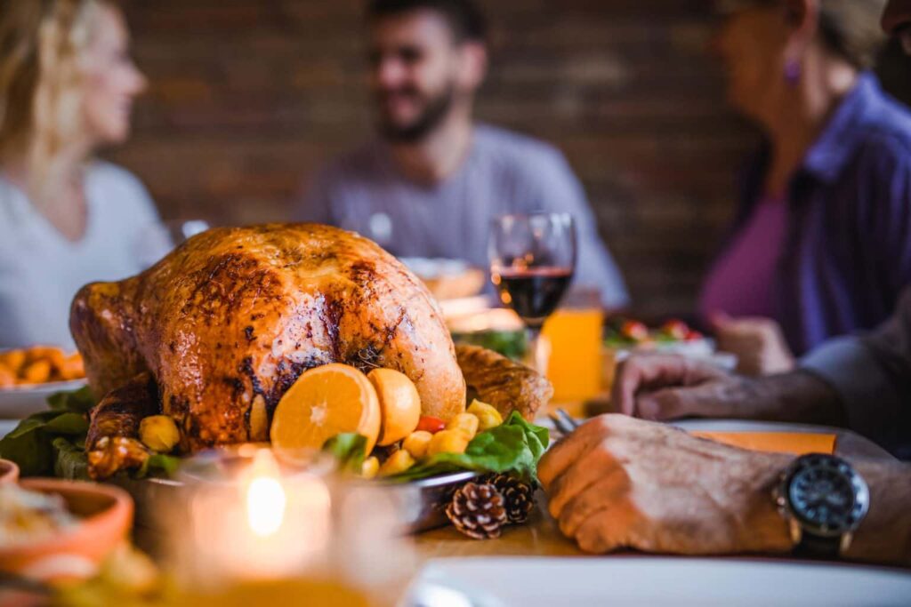 How To Heat Your Home For A Thanksgiving Gathering family eating dinner