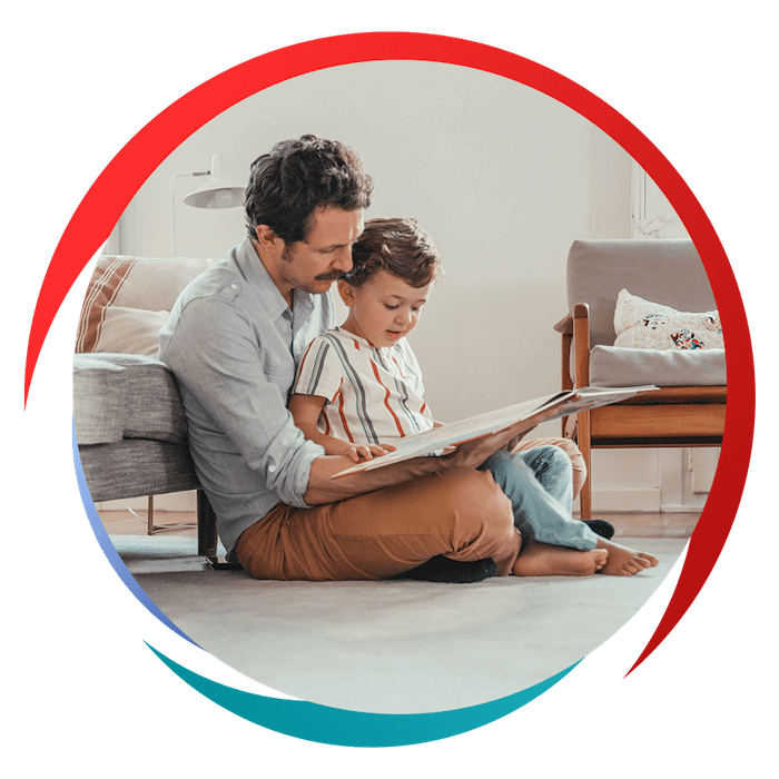 father reading a book to toddler