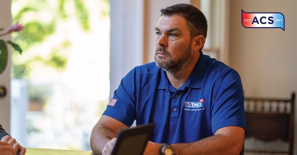 AC repairman sitting at table