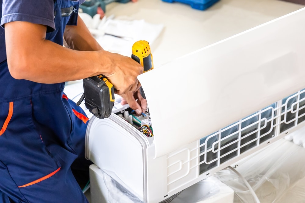 Air conditioning technicians install new air conditioners in homes, Repairman fix air conditioning systems, Male technician service for repair and maintenance of air conditioners